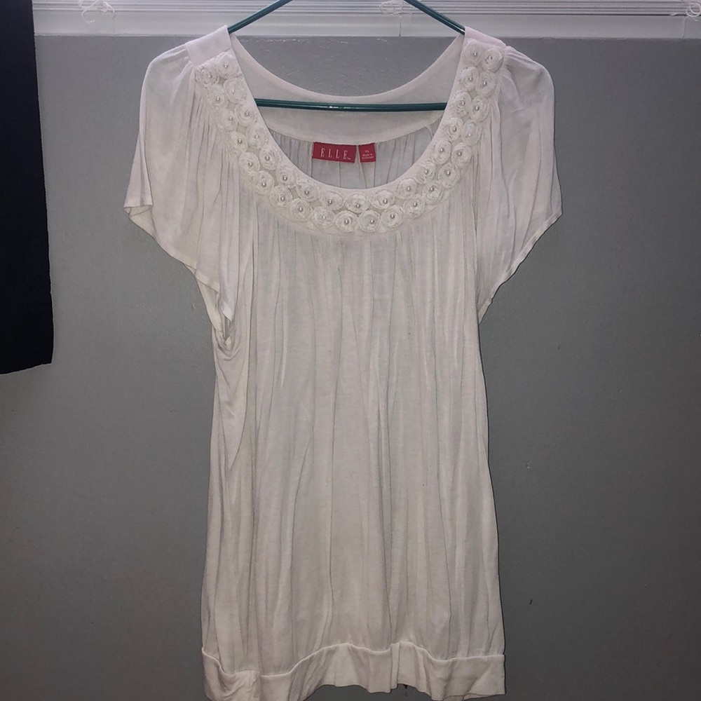 White blouse with white flowers around collar